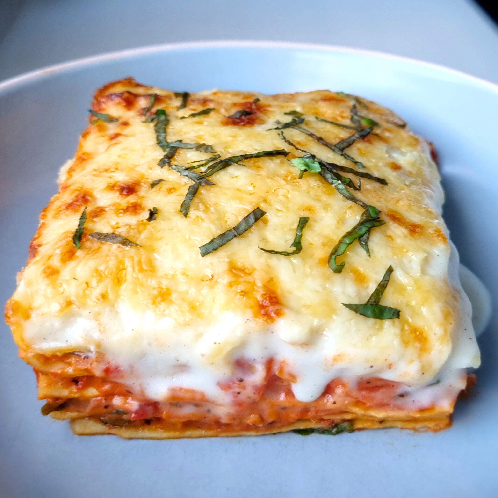 Vegetarische groentelasagne met tomatensaus, puntpaprika, winterpeen, ui, knoflook en ricotta